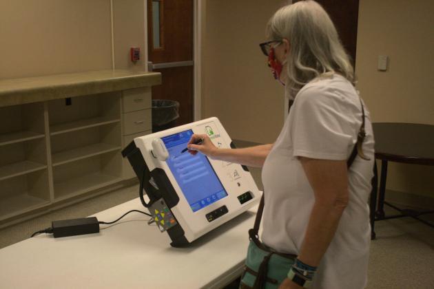 Leslie Landreth selects from a list of choices on the ballot-marking machine in this 2020 photo. Photo by Julianne Hodges
