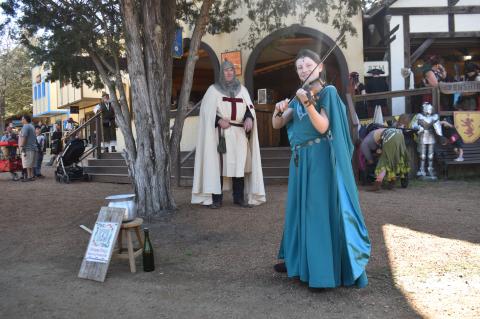 Princess Emlyn plays at the Sherwood Forest Faire in Paige March 4 as a knight looks on. Photo by Fernando Castro