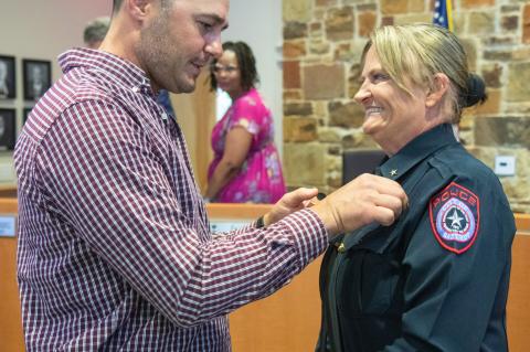 Vicky Steffanic has her police chief badge pinned on her uniform by husband Matthew Steffanic during the Bastrop City Council meeting April 11. Courtesy photo / City of Bastrop