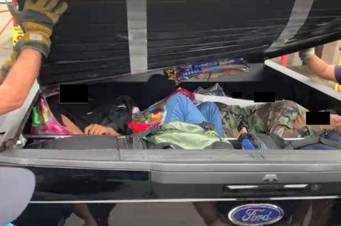 Migrants lay trapped inside the bed cover of a pickup truck in this undated photo from the U.S. Department of Justice. Courtesy photo / U.S. Department of Justice
