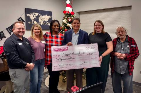 CAC Board Treasurer Eric Farley, CAC Board President Val Butcher, community member Sumai Lokumbe, Lost Pines Toyota Dealer Principal Carlos Liriano, CAC Executive Director Meagan Webb and Director of the Honor Choir Bill Owens with the sizable donation. Photo courtesy Lost Pines Toyota 