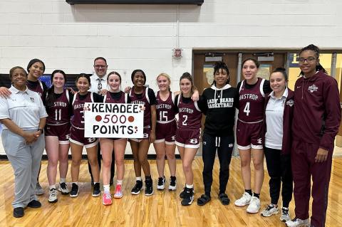 Bastrop High School girls varsity basketball sophomore Kenadee Lawhon poses with teammates and coaches Jan. 19 following the Lady Bears’ game at Georgetown High School to celebrate her 500th career point scored. Photo courtesy of Bastrop ISD