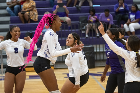 The Elgin High School varsity volleyball team celebrates together on Aug. 25 during a home match against Round Rock Meridian World School. Photo by Marcial Guajardo