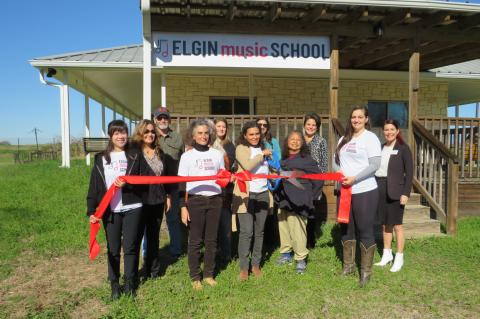 Gabrielle Rosa Amaro (middle) celebrates the opening of Elgin Music School with staff, chamber and community members. Photo by Fernando Castro.