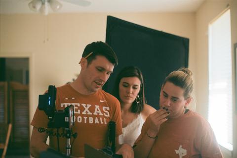 Producers Chris Luner (left) and Aubrey Elenz (middle) collaborating with writer/director Sophie Miller on a scene centered around Texas football. Photo by Cooper Gordon