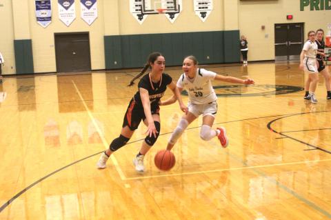 Smithville High School girls varsity basketball senior Avery Bezner drives against a defender Jan. 12 during the Lady Tigers’ district game at Taylor High School. Photo by Andrew Salmi