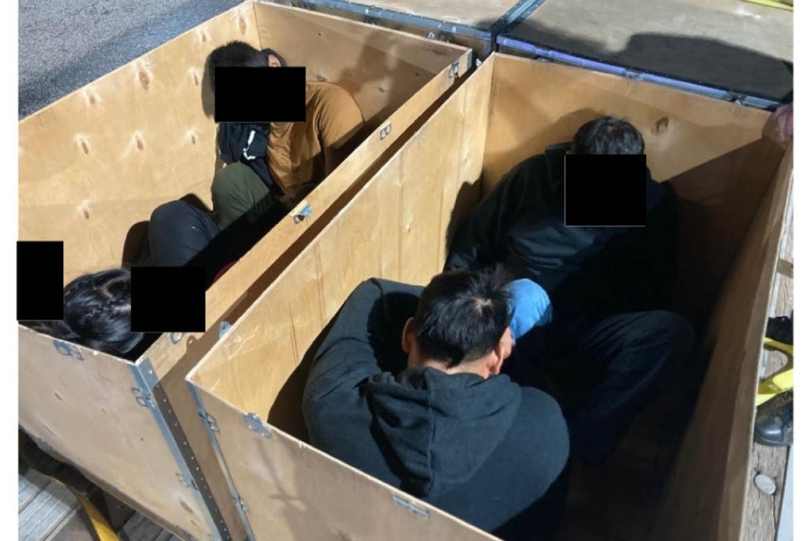 Migrants sit inside a human crate in this undated photo from the U.S. Department of Justice. Courtesy photo / U.S. Department of Justice