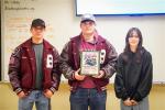 Clayton Sherman, Kevin Hoefer and Laina McDonald receive a plaque from the Bastrop Area Cruisers Feb. 3 in Bastrop for volunteer work. Courtesy photo